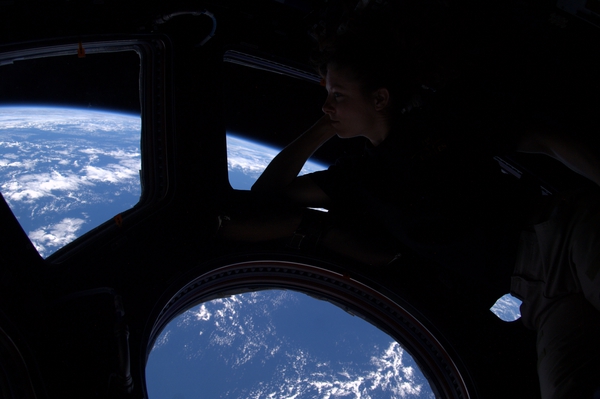 Peering out of the windows of the International Space Station (ISS), astronaut Tracy Caldwell Dyson takes in the planet on which we were all born.
